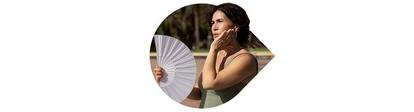 Woman using a hand-fan to deal with the heat.